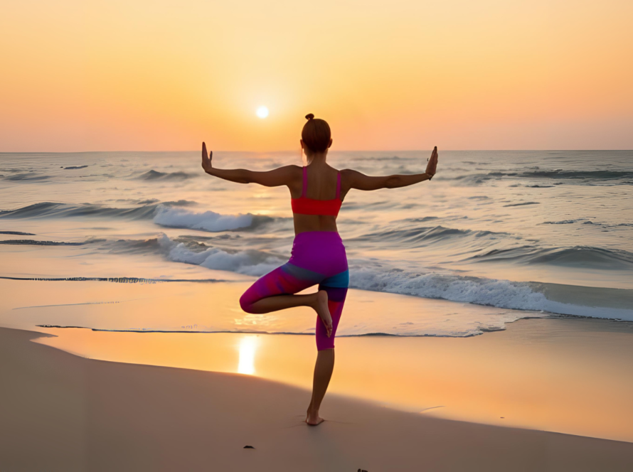 Woman doing yoga on beach at sunrise