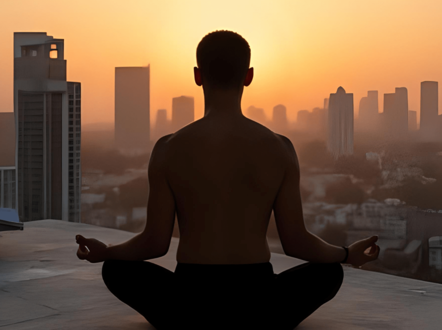 Man meditating on rooftop at sunrise, city background
