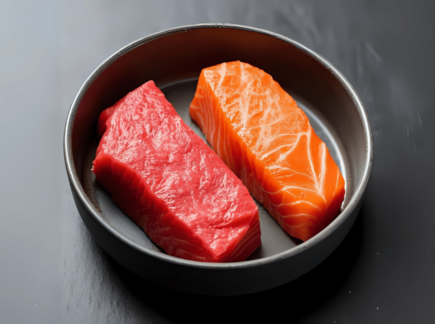 Raw tuna and salmon fillets in metal bowl