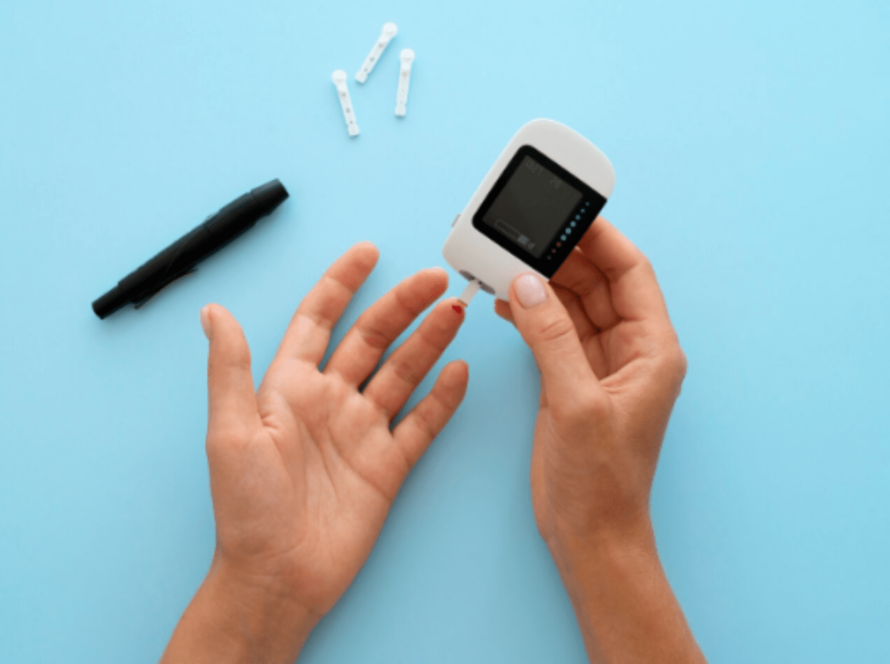 Person testing glucose with fingertip blood sample